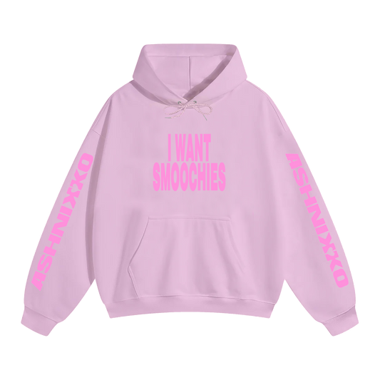 A classic pink pullover hoodie with I Want Smoochies across the front and Ashnikko logo along the arms. 